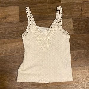Cream colored tank top; crochet material; inside lined with fabric